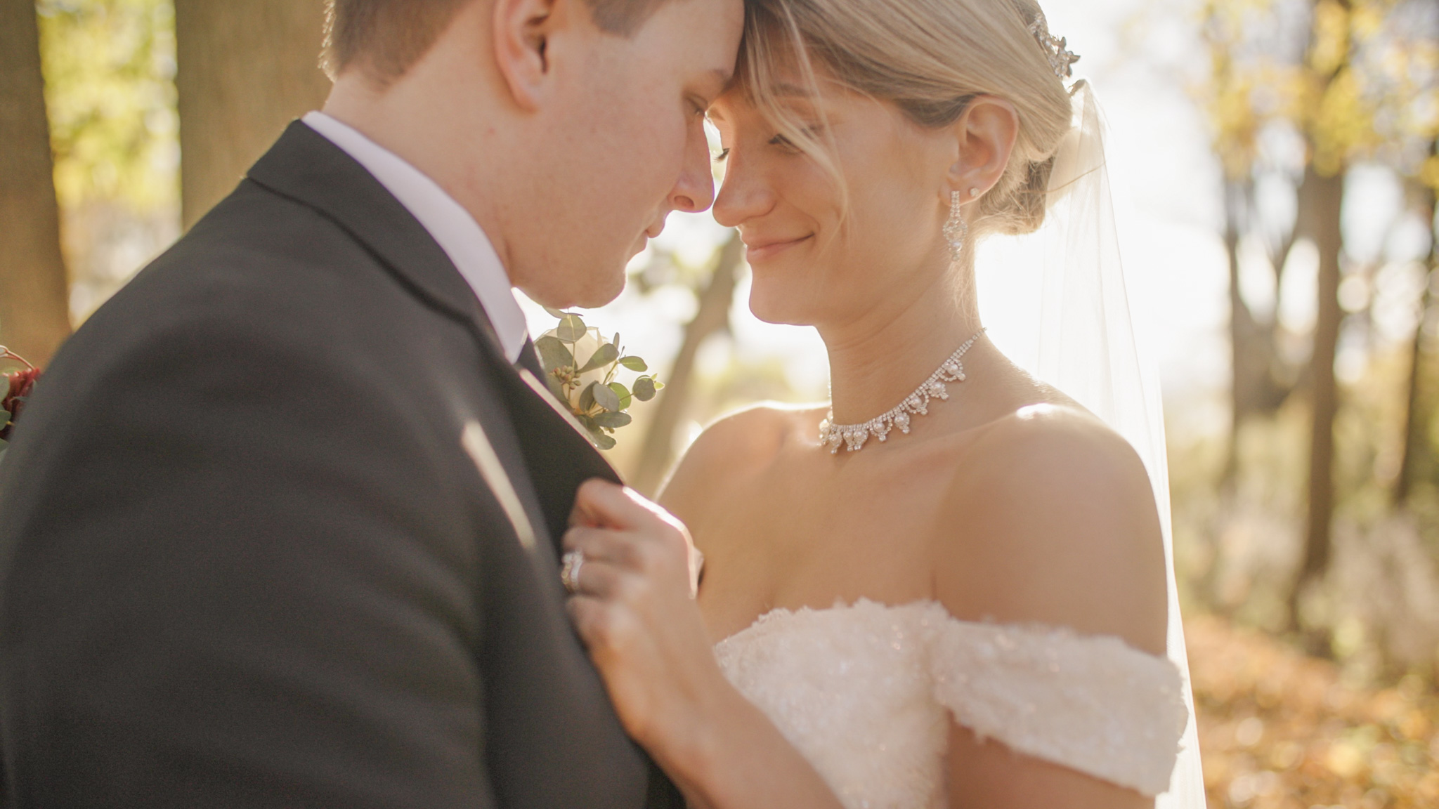 A bride and groom pressing their foreheads together in a quiet, intimate moment.