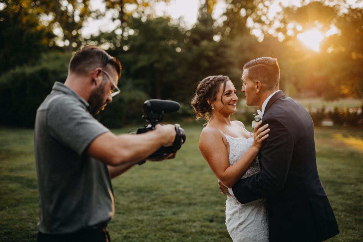 John filming a couple in golden hour light during their first look.